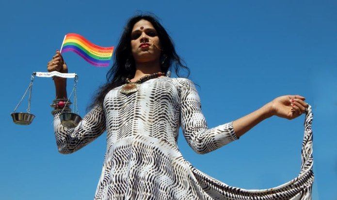 LGBT activist holding flag and scales of justice