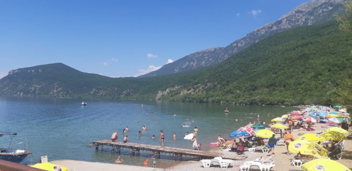 A sandy beach in Ljubanishte, Ohrid Lake, North Macedonia on July 24, 2020. Photo by Filip Stojanovski, CC BY.