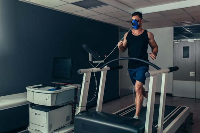 Male athlete having VO2 max test on treadmill.