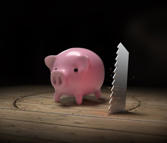 Piggy bank with knife sawing under it