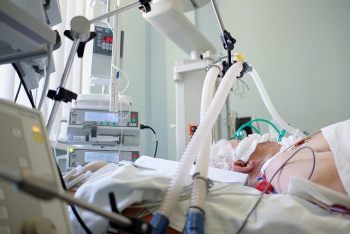 A man in hospital on a ventilator