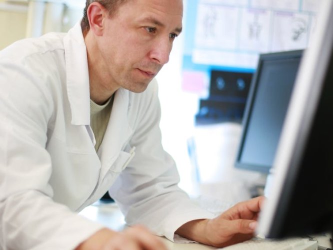 A doctor using a computer