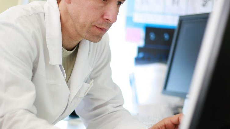 A doctor using a computer