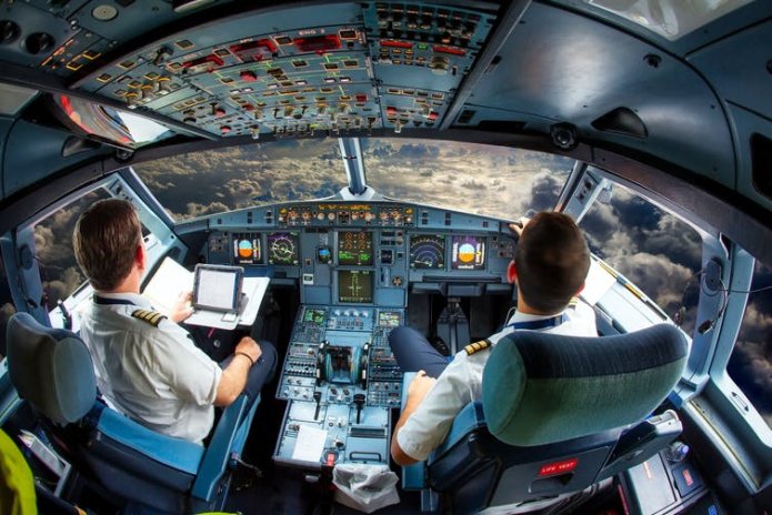 Two pilots in the cockpit of a plane