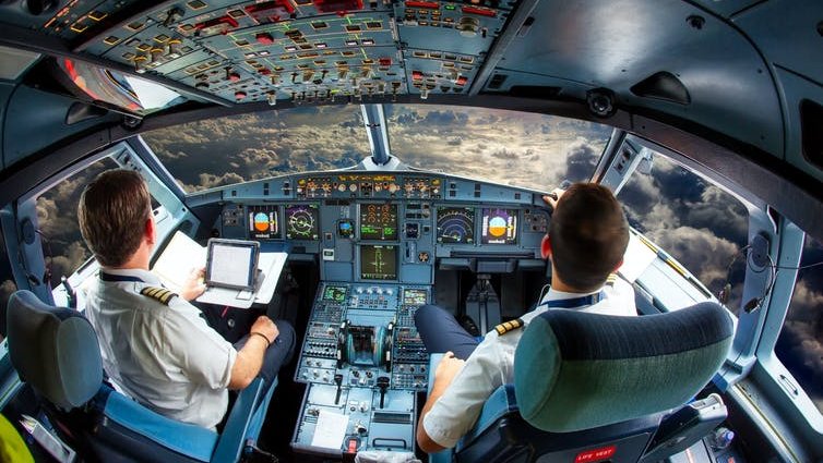 Two pilots in the cockpit of a plane