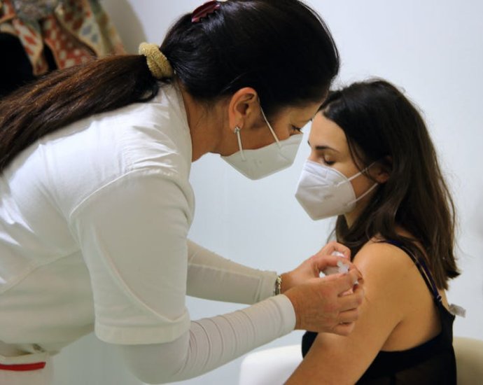 An Italian health worker getting vaccinated