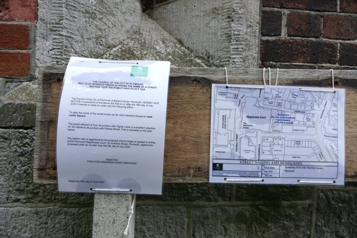 Two signs pinned to a street sign informing the public that the council plans to rename Sir John Hawkins Square.