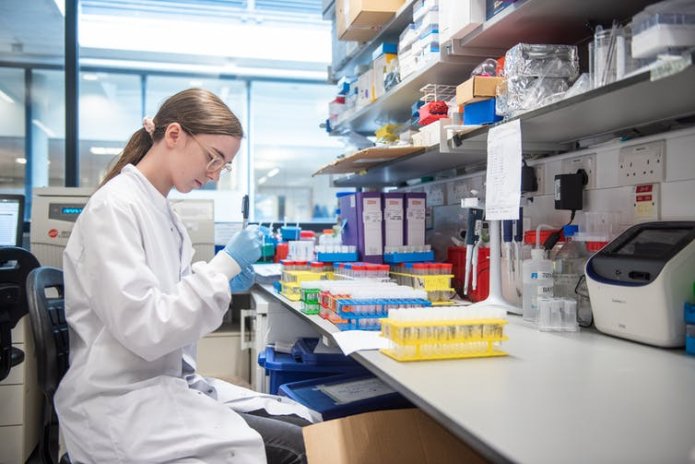 A scientist in a lab working on the development of the Oxford/AstraZeneca vaccine