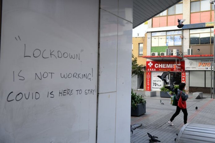 Graffiti that reads: 'Lockdown is not working! COVID is here to stay.'