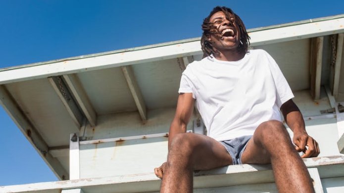 Man outdoors in shorts and T-shirt.