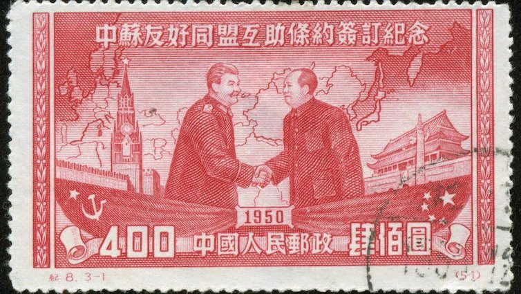 A stamp showing Joseph Stalin and Mao Zedong shaking hands, Chinese characters and the date 1950