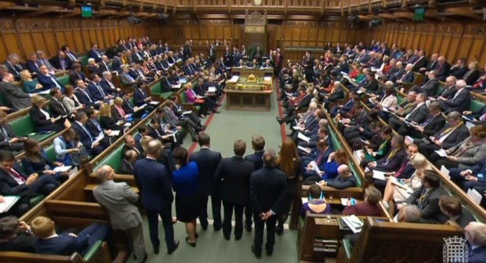 Photo of UK parliamentarians filling the benches in the House of Commons