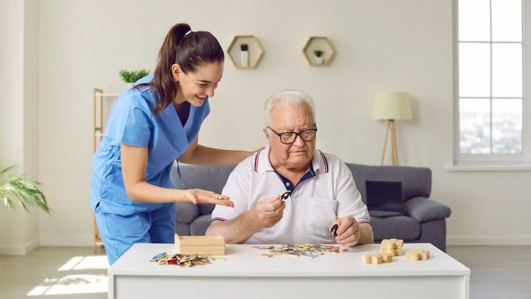 An elderly man and his carer