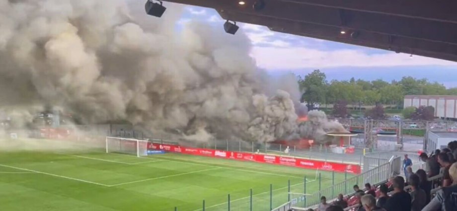 Football stadium evacuated after huge fire with smoke pouring over pitch