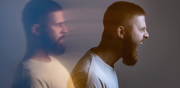 Angry furious businesswoman working on computer, screaming with alphabet letter coming out of open mouth