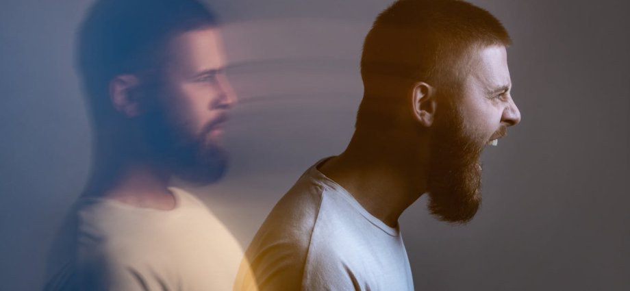 Angry furious businesswoman working on computer, screaming with alphabet letter coming out of open mouth