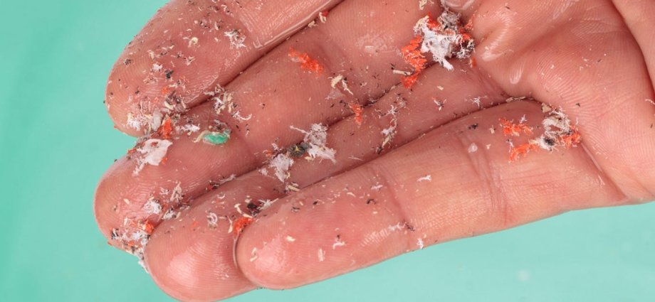 A hand holding a lit cigarette.